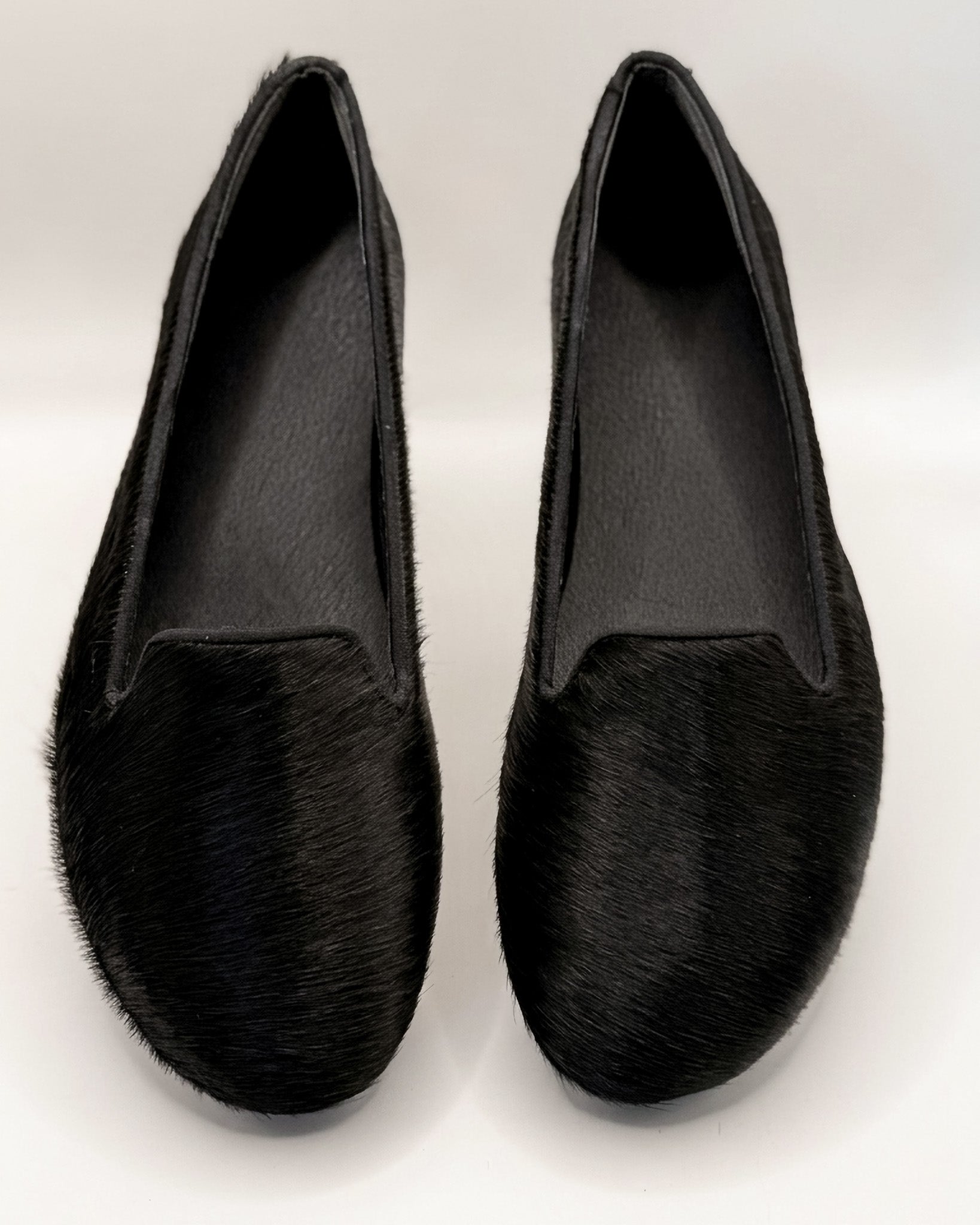 Pair of black loafers on a white background